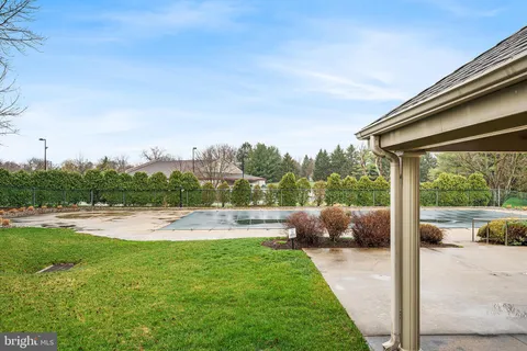 a view of a patio with lawn chairs under an umbrella