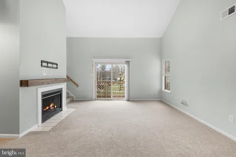 a view of empty room with a fireplace