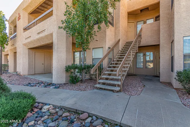 a view of front door of house with stairs