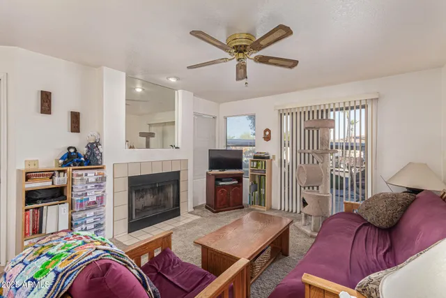 a living room with furniture fireplace and flat screen tv