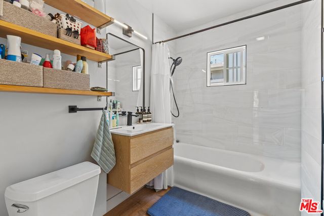 a bathroom with a sink a mirror and a toilet