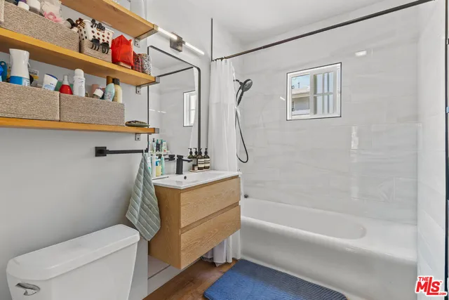 a bathroom with a sink a mirror and a toilet