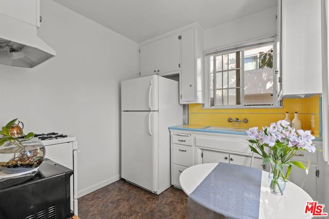 a white refrigerator freezer sitting in a kitchen