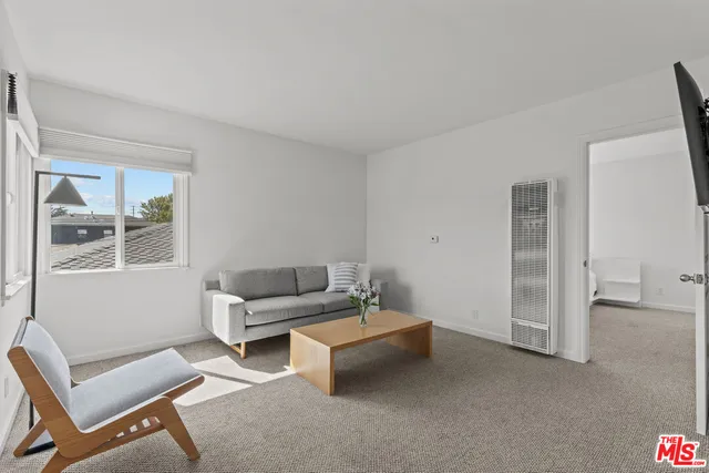 a living room with furniture and windows
