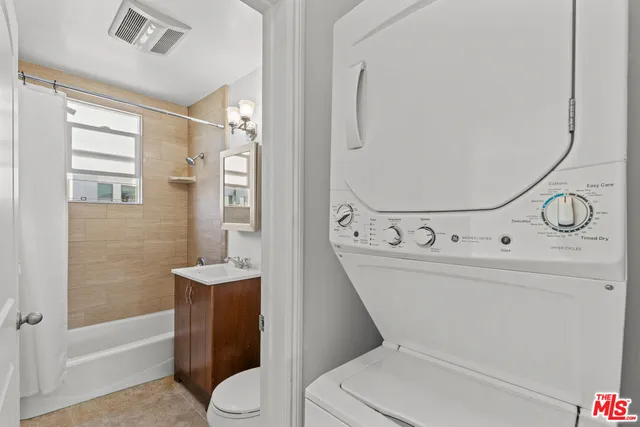 a bathroom with a toilet sink and shower