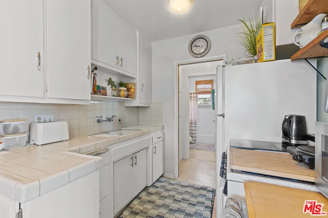 a kitchen with a sink and a stove top oven