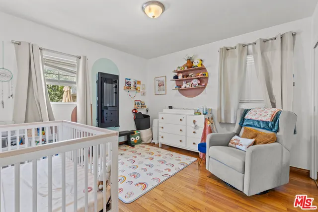 a bedroom with furniture and a large window