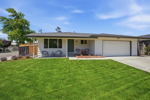 a front view of house with yard and green space