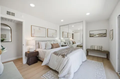 a spacious bedroom with a bed and a couch