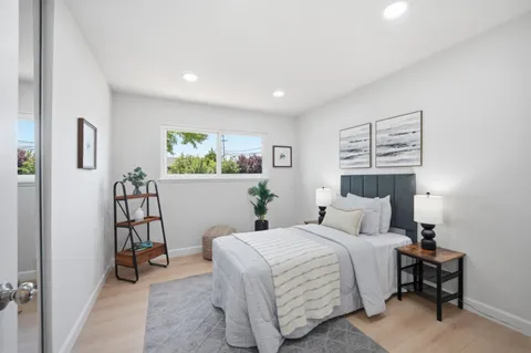 a bedroom with a bed and a window