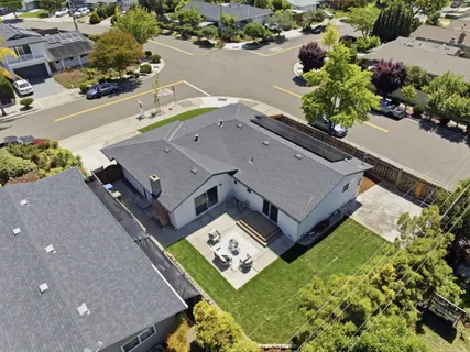 an aerial view of a house with a garden and mountain view