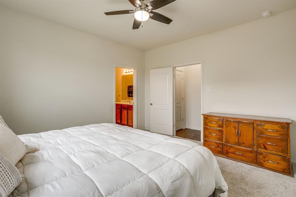 136 Kennedy Drive Venus, TX 76084 - Photo 10 of 27 a bedroom with a large bed and ceiling fan