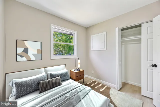 a bedroom with a bed and a painting on the wall