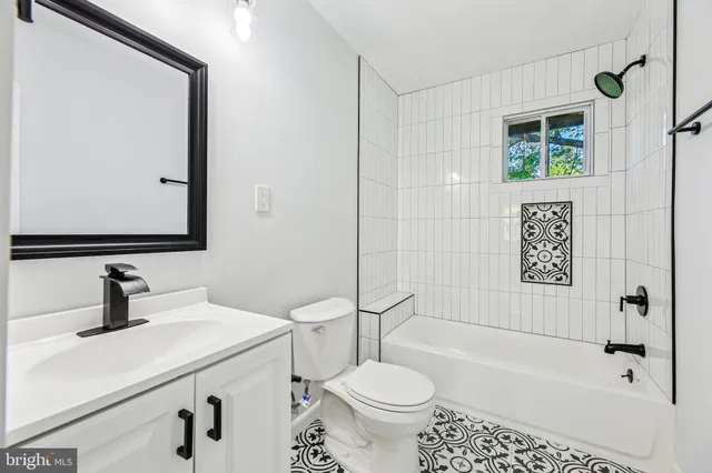 a bathroom with a sink toilet a mirror and shower