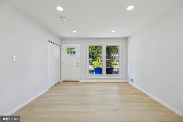 wooden floor in an empty room with a window