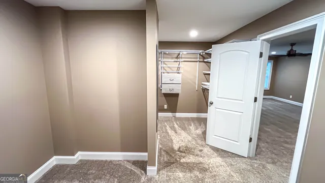 a view of kitchen with refrigerator and white walls