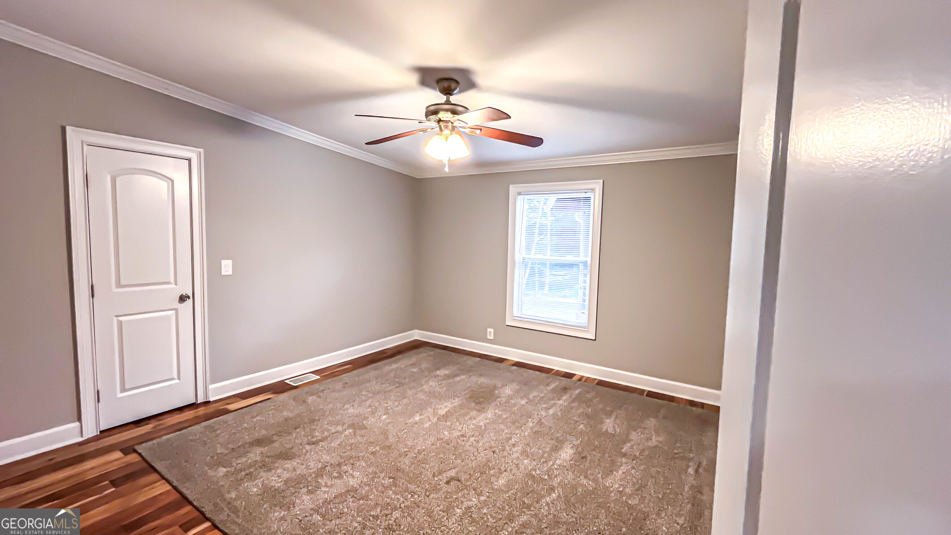 1025 Dailey Mill Road McDonough, GA 30253 - Photo 16 of 58 an empty room with windows and fan