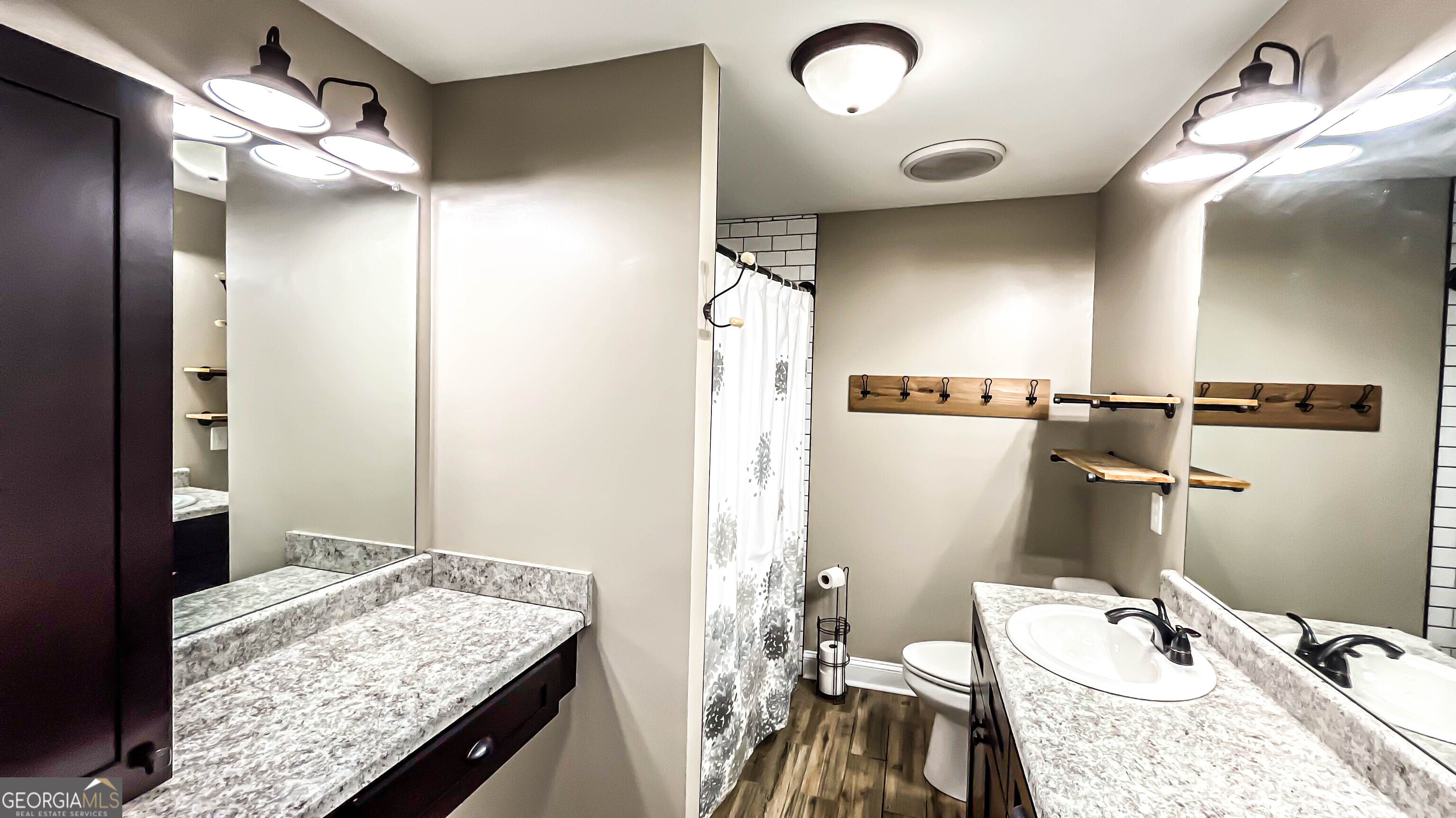 1025 Dailey Mill Road McDonough, GA 30253 - Photo 17 of 58 a bathroom with a granite countertop sink a mirror and shower