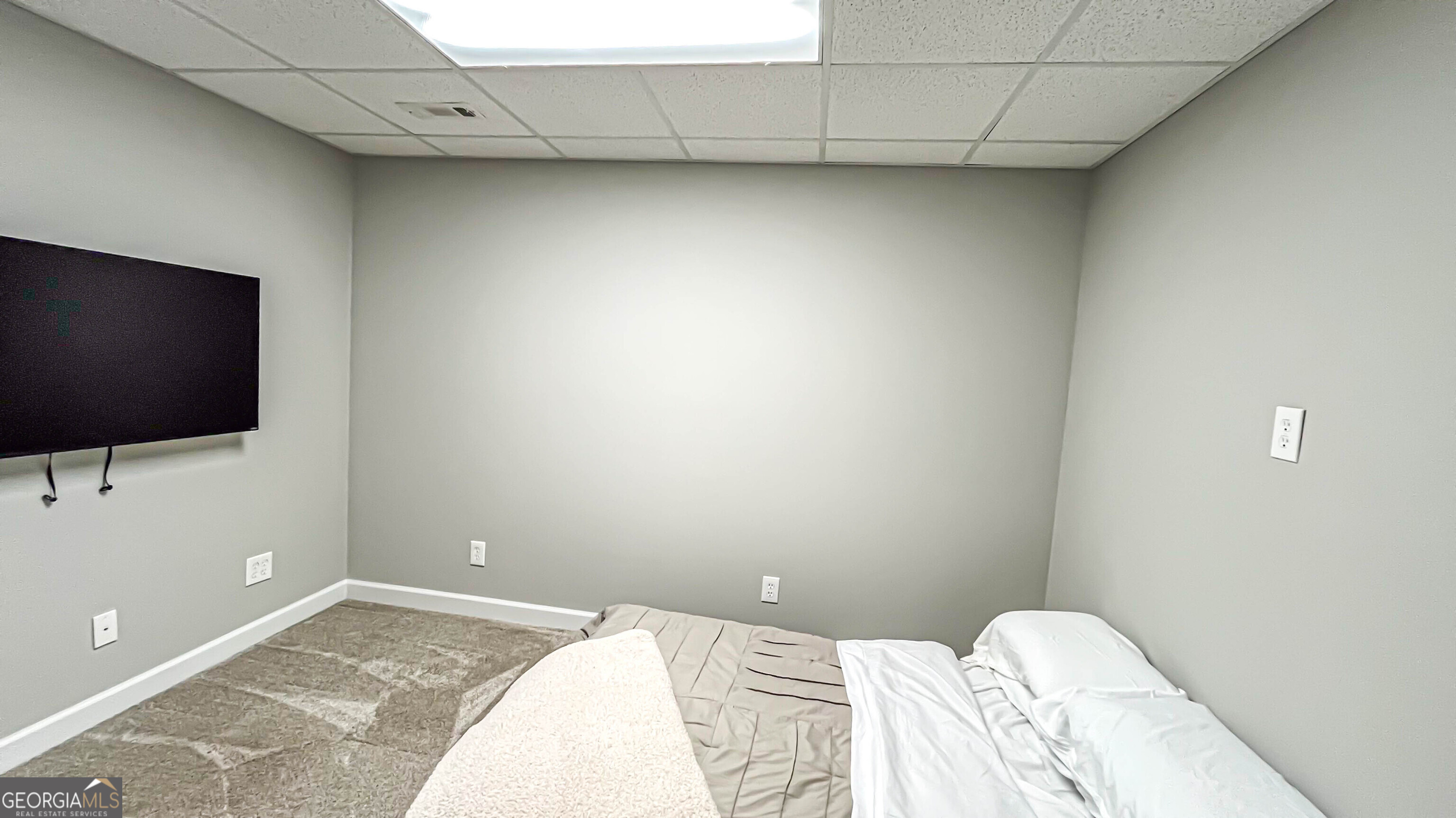 1025 Dailey Mill Road McDonough, GA 30253 - Photo 23 of 58 a bedroom with a bed and a flat screen tv