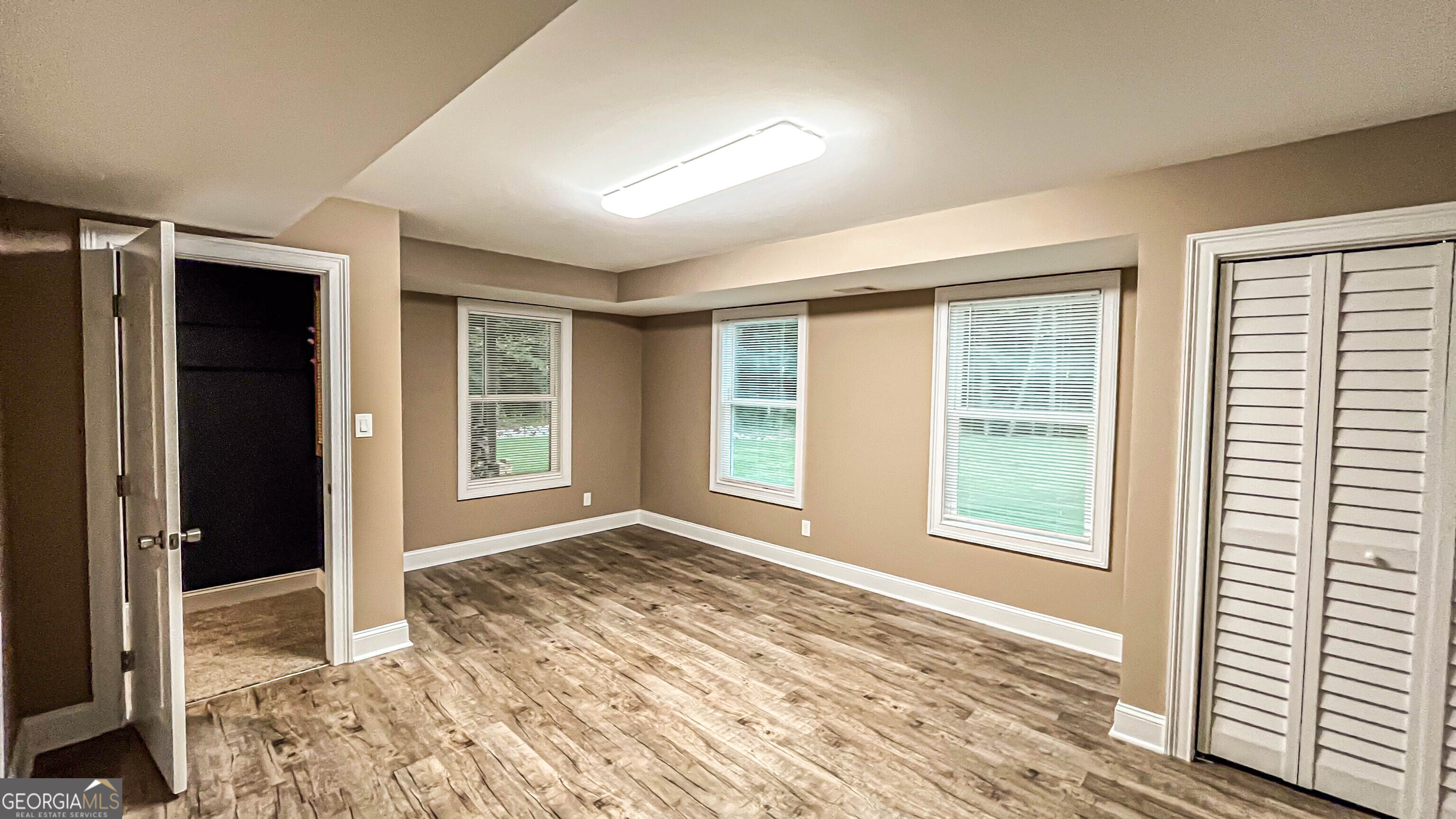 1025 Dailey Mill Road McDonough, GA 30253 - Photo 24 of 58 a view of an empty room with wooden floor and a window