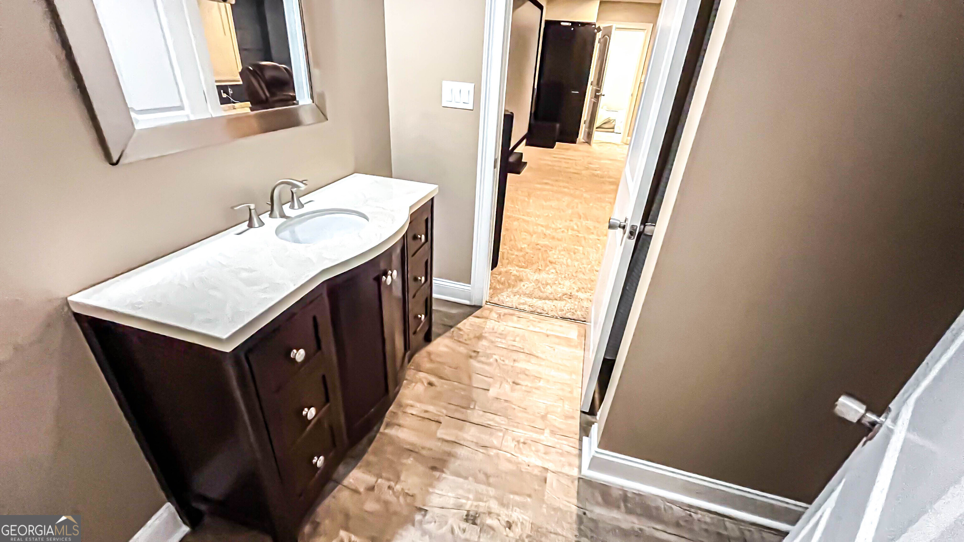 1025 Dailey Mill Road McDonough, GA 30253 - Photo 25 of 58 a bathroom with a sink a mirror and a toilet