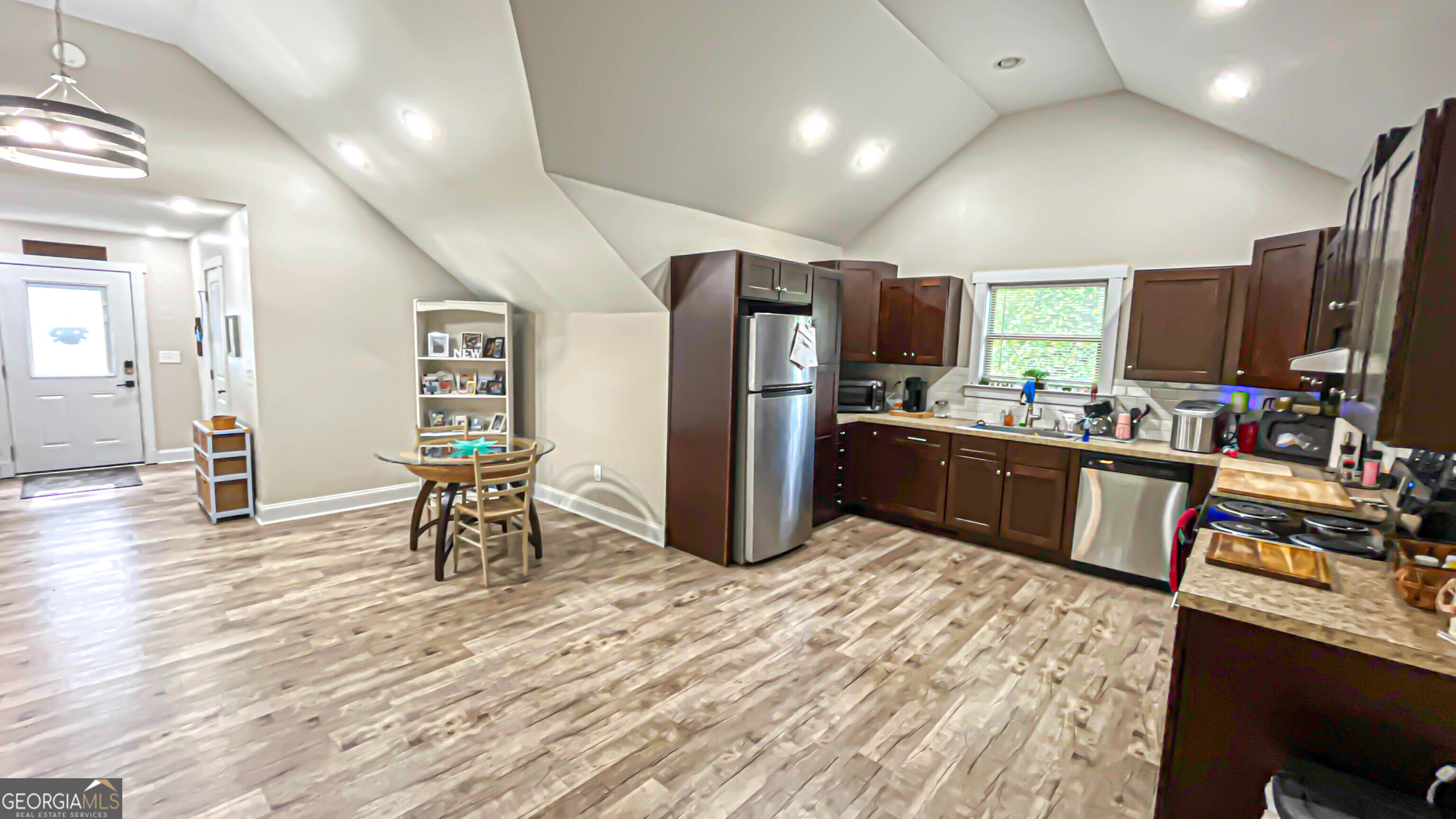 1025 Dailey Mill Road McDonough, GA 30253 - Photo 43 of 58 a kitchen with stainless steel appliances a refrigerator and wooden floor