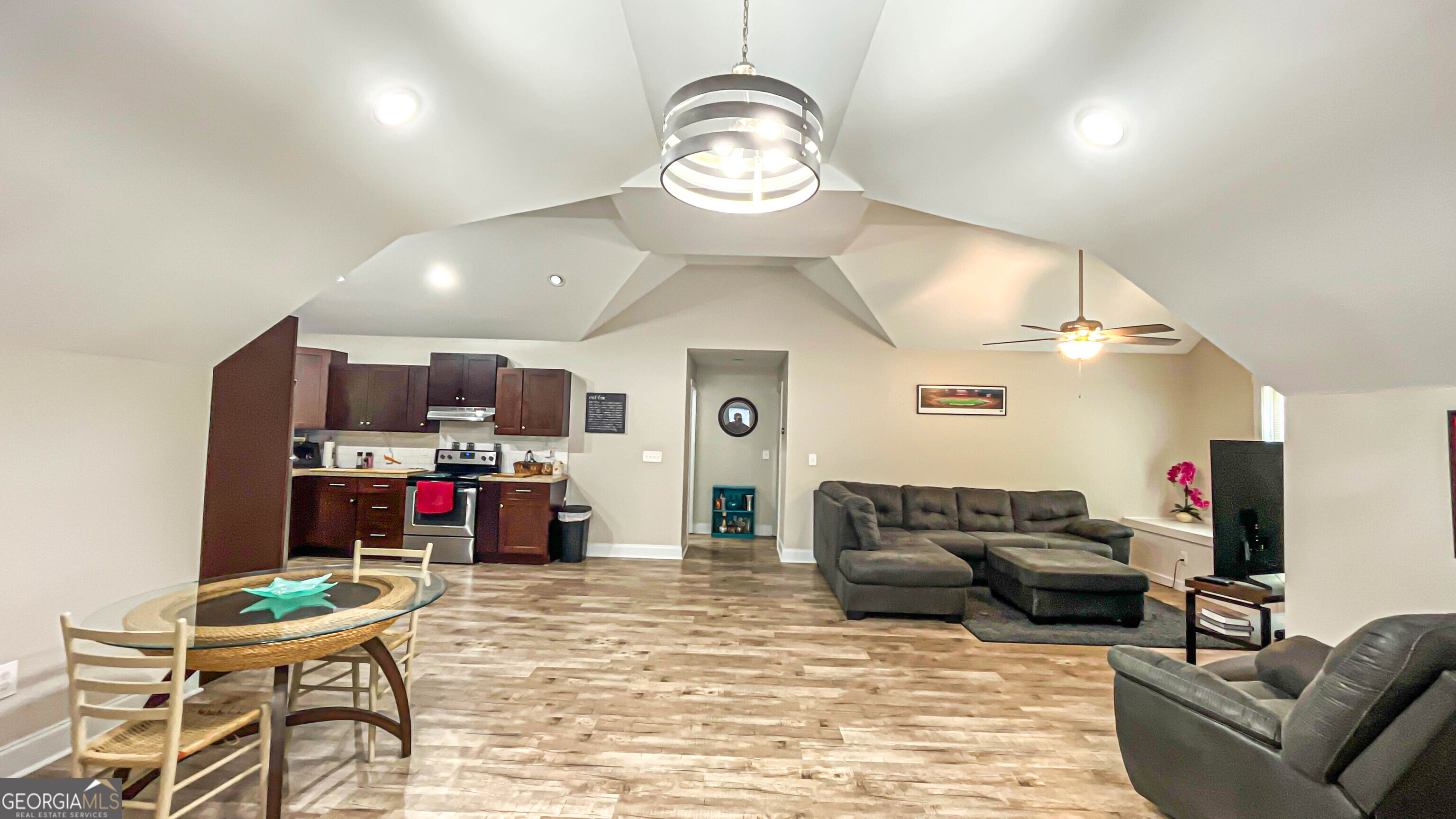 1025 Dailey Mill Road McDonough, GA 30253 - Photo 44 of 58 a living room with furniture a flat screen tv and kitchen view