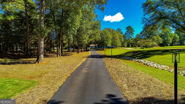 a view of a house with a yard and trees