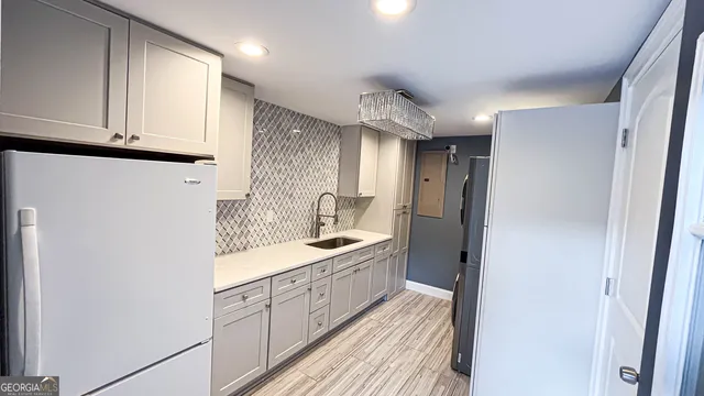 a kitchen with a sink and refrigerator