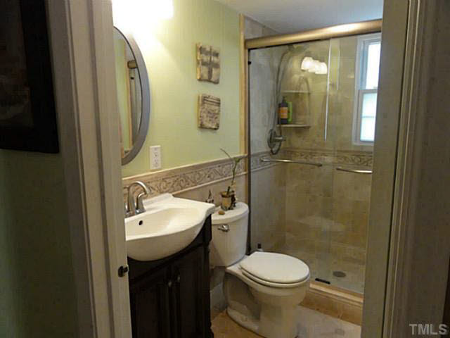 1008 Northclift Drive Raleigh, NC 27609 - Photo 11 of 21 a bathroom with a sink toilet and shower