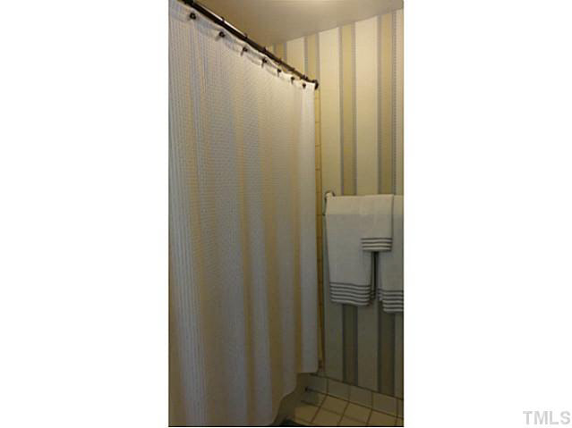 1008 Northclift Drive Raleigh, NC 27609 - Photo 13 of 21 a bathroom with a shower and a mirror