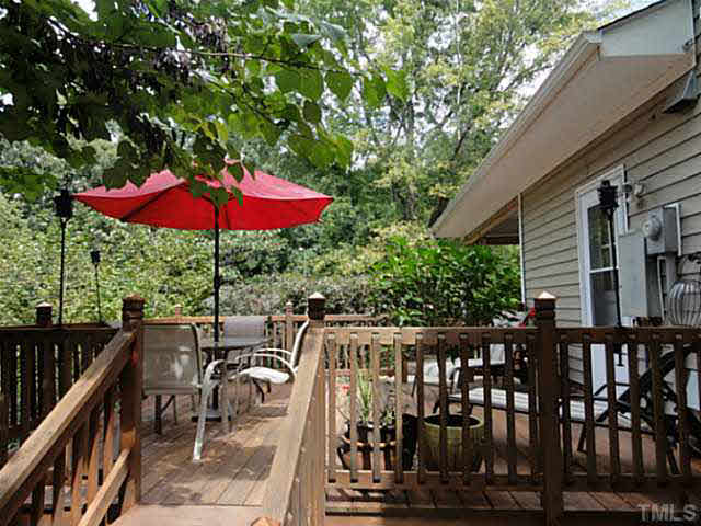 1008 Northclift Drive Raleigh, NC 27609 - Photo 17 of 21 an outdoor view of a patio with chairs under an umbrella