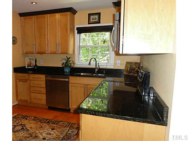 1008 Northclift Drive Raleigh, NC 27609 - Photo 3 of 21 a kitchen with a sink a window and cabinets