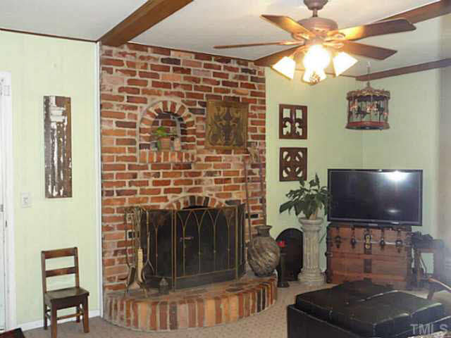 1008 Northclift Drive Raleigh, NC 27609 - Photo 6 of 21 a living room with furniture and a flat screen tv
