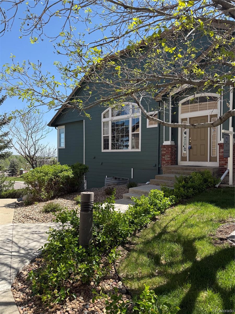 2855 Rock Creek Circle, Unit 129 Louisville, CO 80027 - Photo 1 of 45 a front view of a house with garden
