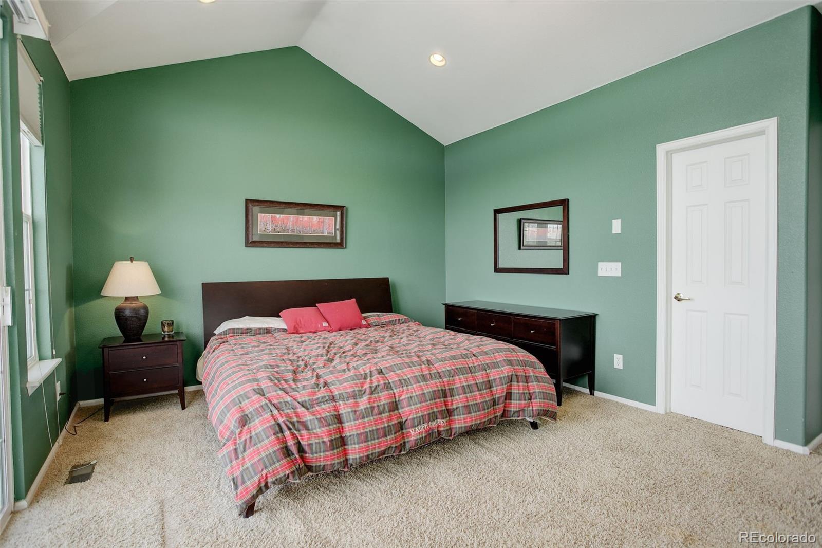 2855 Rock Creek Circle, Unit 129 Louisville, CO 80027 - Photo 13 of 45 a bedroom with a bed and a painting