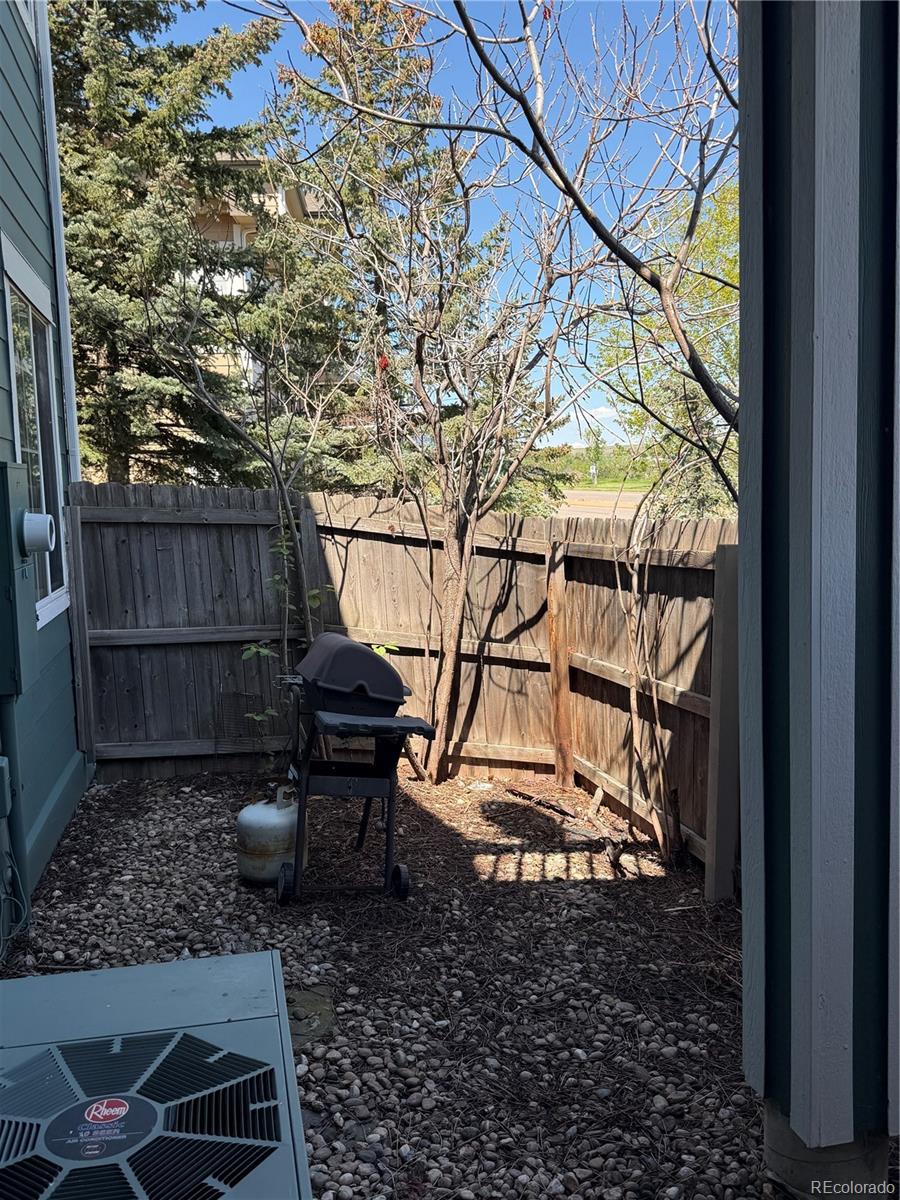 2855 Rock Creek Circle, Unit 129 Louisville, CO 80027 - Photo 29 of 45 a backyard of a house with barbeque oven table and chairs