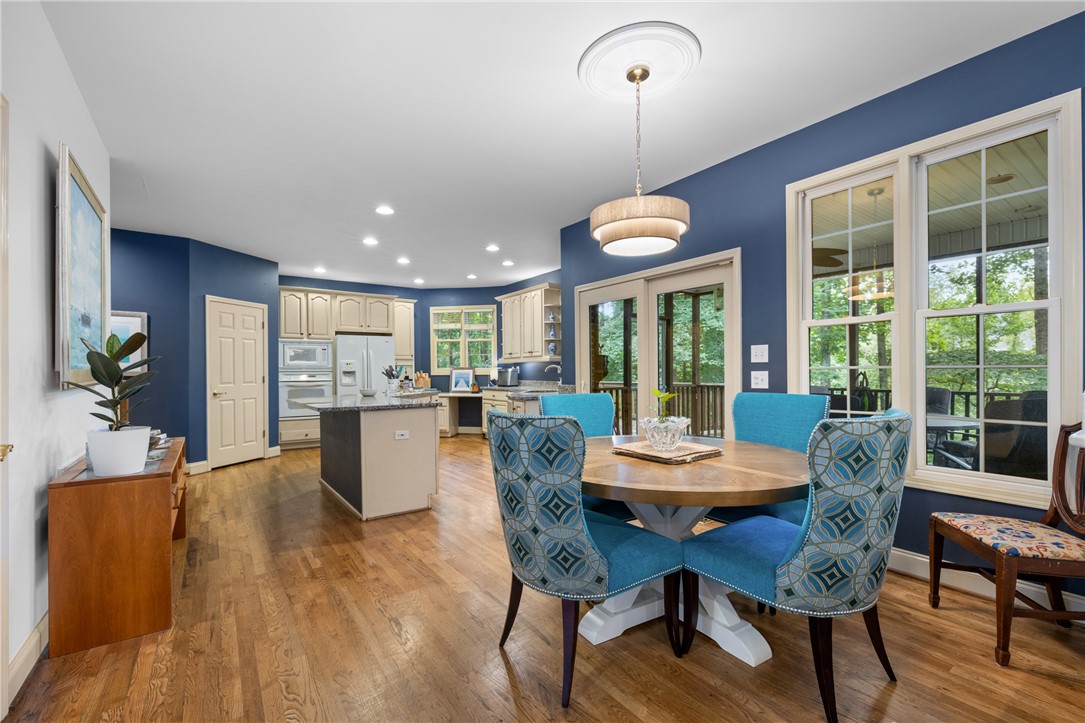 106 Red Maple Way Clemson, SC 29631 - Photo 12 of 49 Rich hardwood flooring anchors this open layout connecting the dining space to the kitchen.