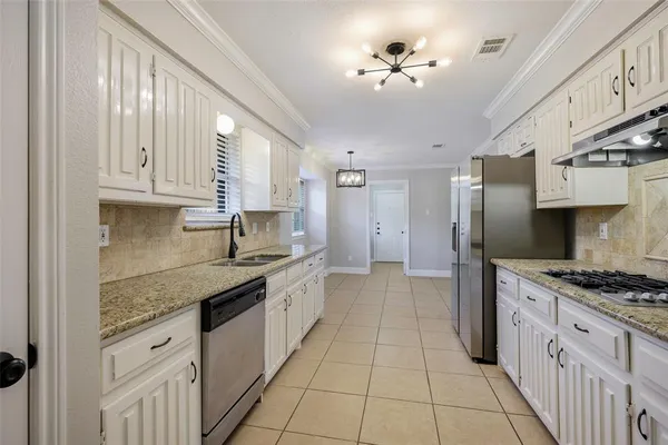 a kitchen with stainless steel appliances granite countertop a stove sink and cabinets