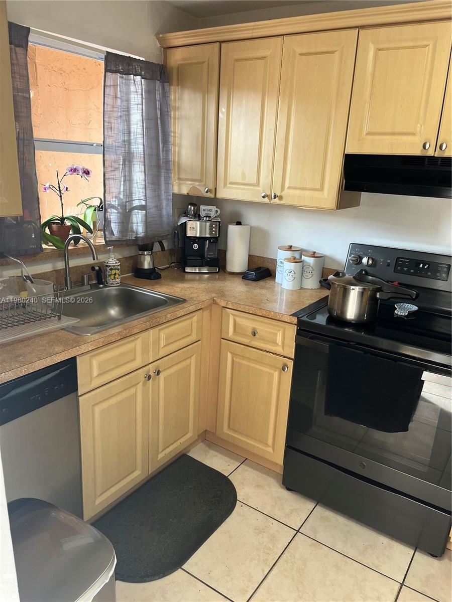 a kitchen with a sink stove and cabinets