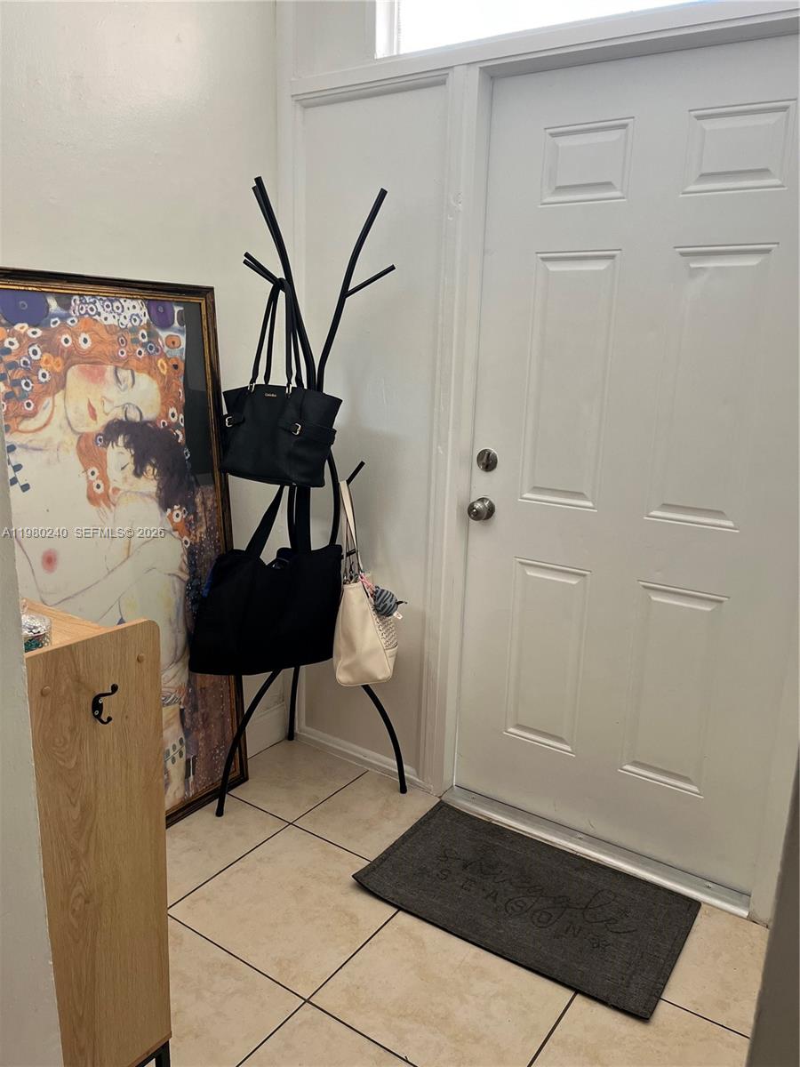 4331 West 11th Lane, Unit 65 Hialeah, FL 33012 - Photo 16 of 21 a view of an entryway with table and chair
