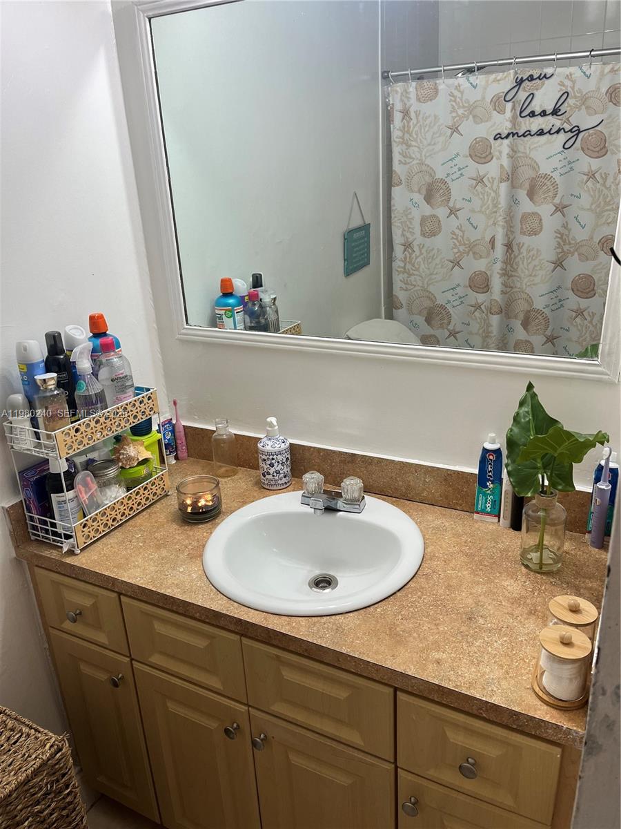4331 West 11th Lane, Unit 65 Hialeah, FL 33012 - Photo 18 of 21 a bathroom with a sink and a mirror