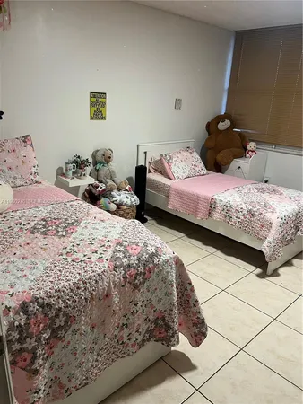 a bedroom with a bed and a stool