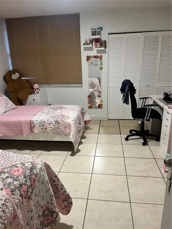 a bedroom with a bed and dresser