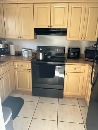 a kitchen with cabinets and appliances