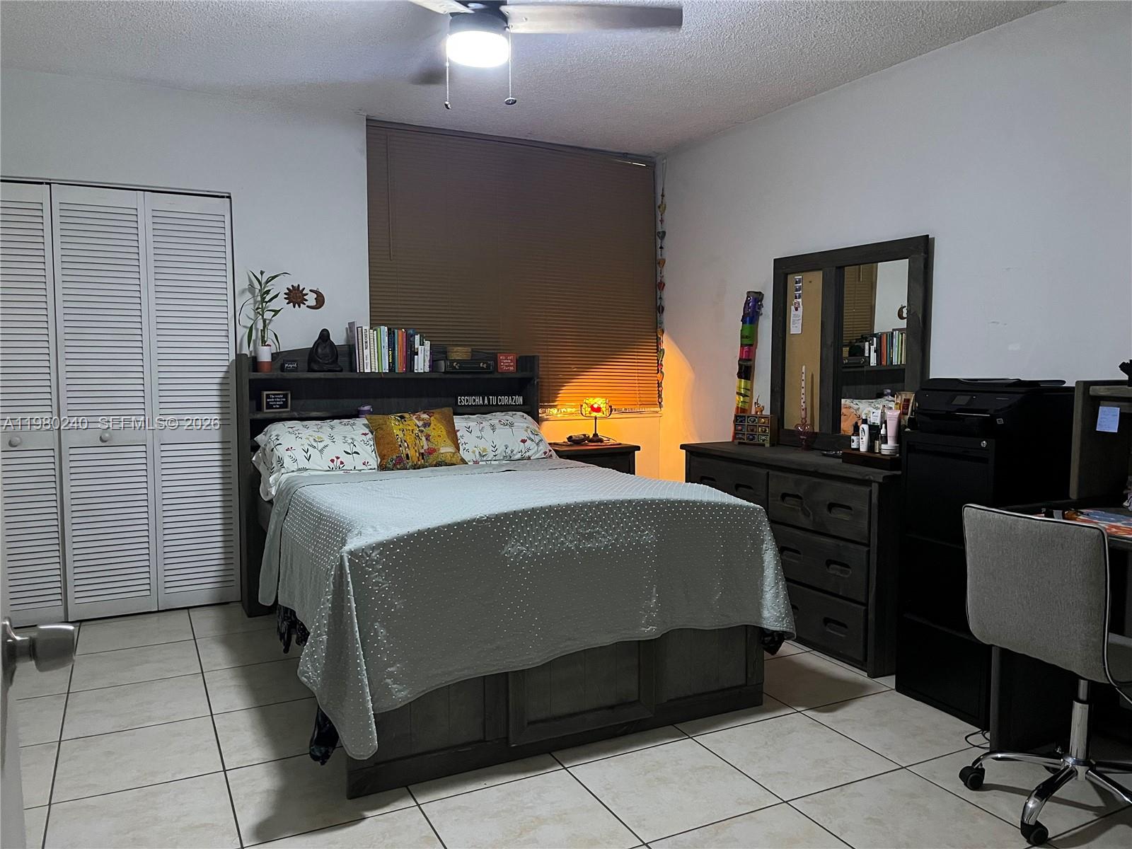 4331 West 11th Lane, Unit 65 Hialeah, FL 33012 - Photo 21 of 21 a bedroom with a bed and dresser