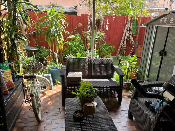 a view of balcony with furniture and flowers