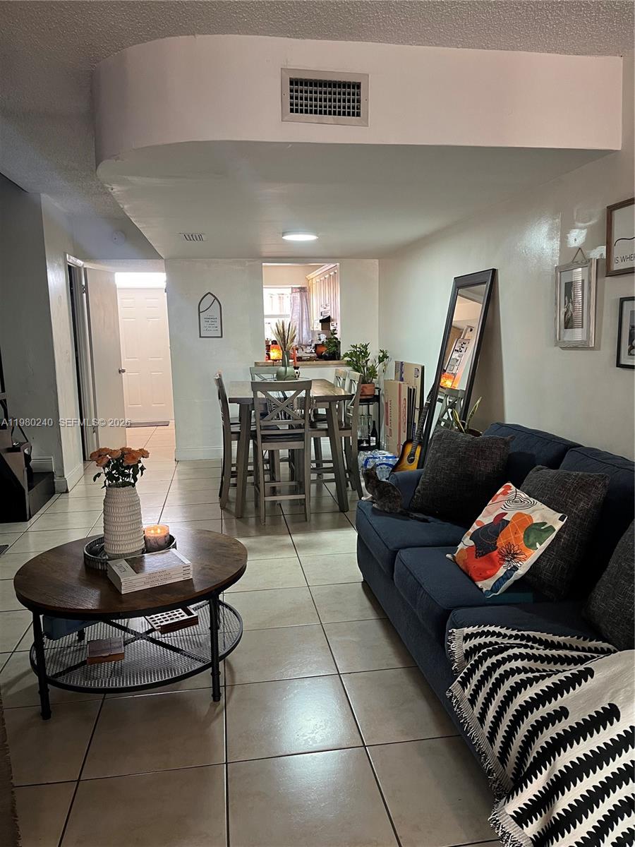 4331 West 11th Lane, Unit 65 Hialeah, FL 33012 - Photo 7 of 21 a living room with furniture and wooden floor