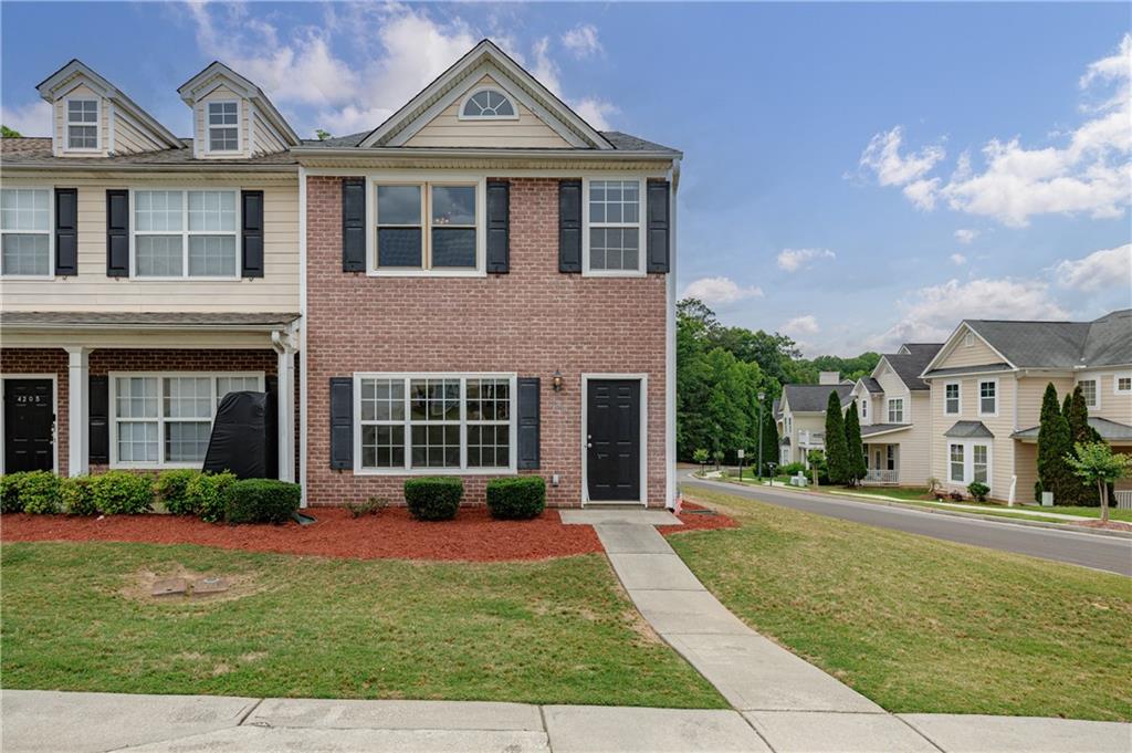 4203 Legacy Square Atlanta, GA 30349 - Photo 1 of 35 a front view of a house with garden