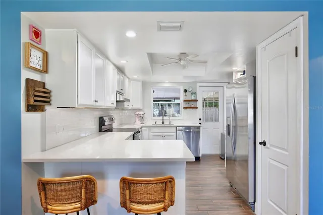 a kitchen with stainless steel appliances a stove a sink and a refrigerator